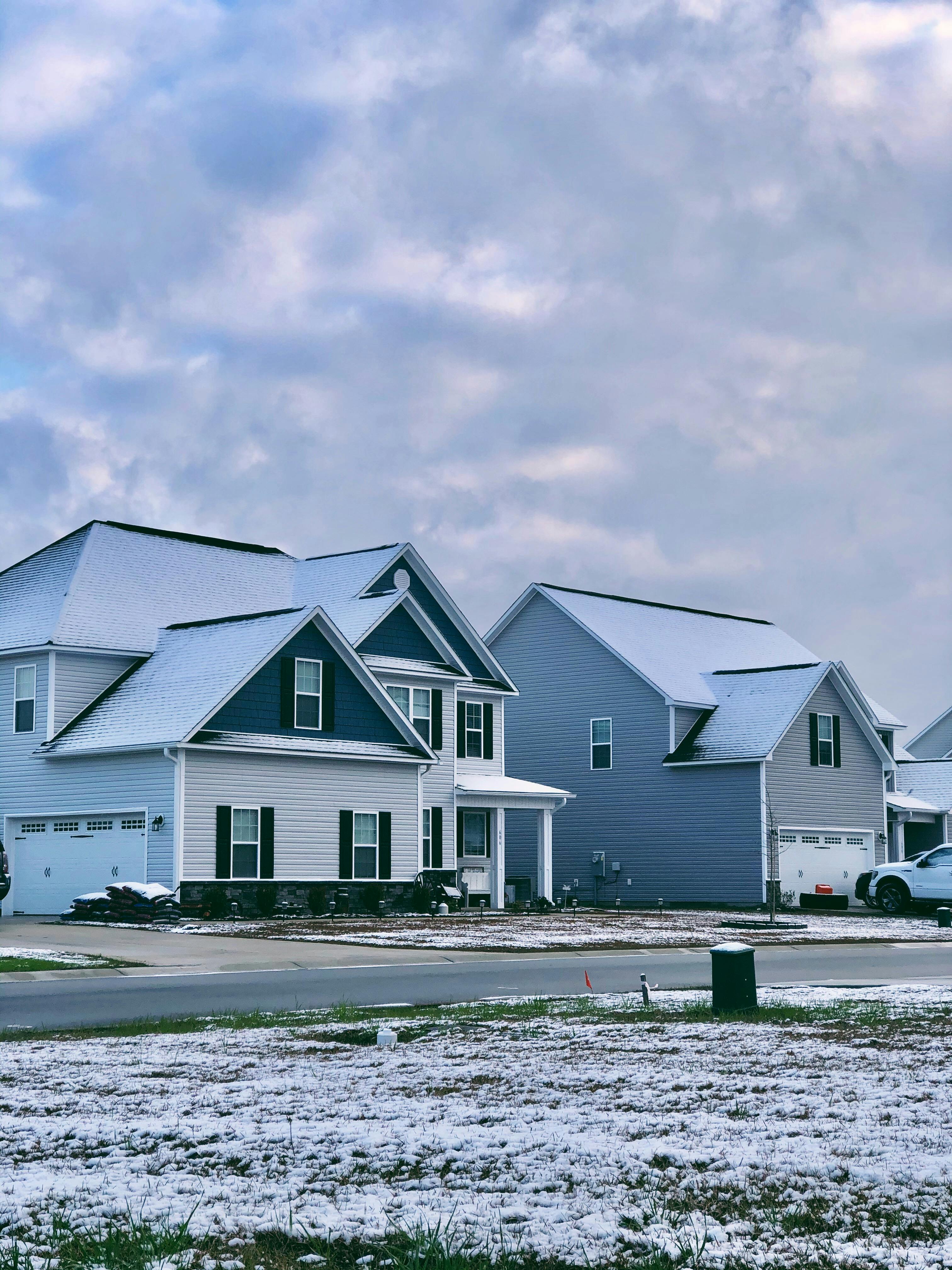 A row of houses with snow on the ground